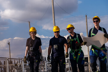 Group of workers walking together at an industrial site under a clear sky in daytime during their shift