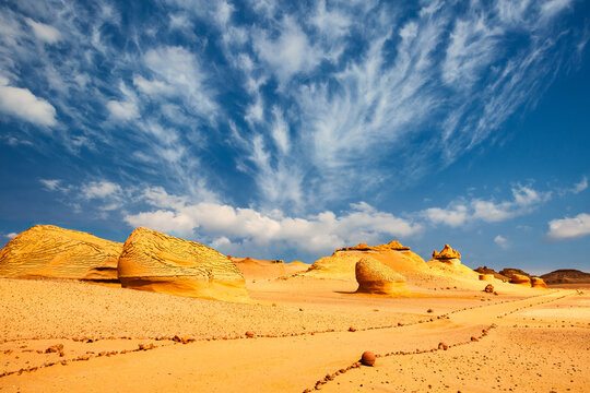 Sand and rock desert landscape with the path, Wadi Hitan, Egypt