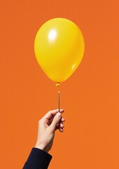 Hand holding pin near balloon
