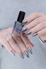 Female hand with long nails and a gray silver manicure