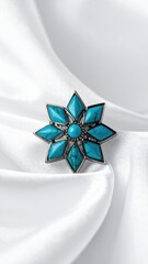 Exquisite Turquoise Starburst Ring Adorned with Faceted Gemstones on Luxurious White Silk Drapery