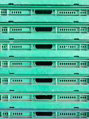 Stacked Green Plastic Industrial Trays.