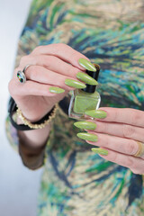 Female hand with long nails and neon yellow green manicure