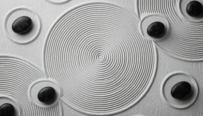Stickers Stenen in het zand Top down view of peaceful zen garden with raked white sand in concentric circles and smooth black stones creating feeling of calm balance and serenity  © Ai Stock Lab