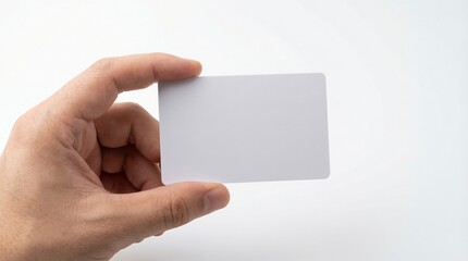 Obraz premium Hand holding a blank white business card or credit card mockup