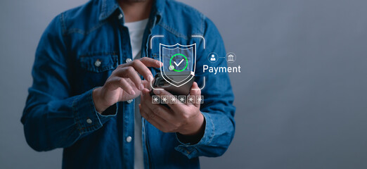 concept of secure digital payments, man using a smartphone with shield icon and checkmark,...