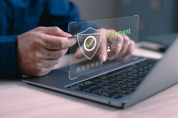 concept of secure online payment. man displaying a credit card and laptop with shield and checkmark icons, symbolizing digital transactions, financial protection and identity verification