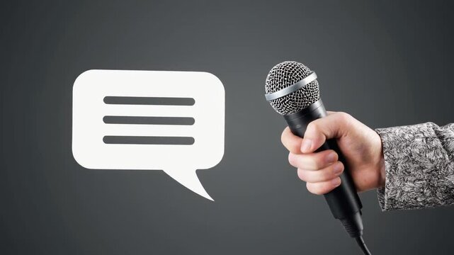 Hand Holding a Microphone Next to a White Speech Bubble Icon Keywords: hand, holding, microphone, speech, bubble, icon, communication, talk, speaking, interview, news, media, podcast