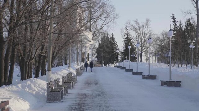 28 December 2025, Barnaul, Russia. People walk along the central city alley in winter, enjoying snowy urban streets, seasonal outdoor activities, and cityscape.