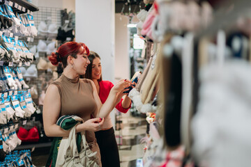 Young women shopping for underwear in store