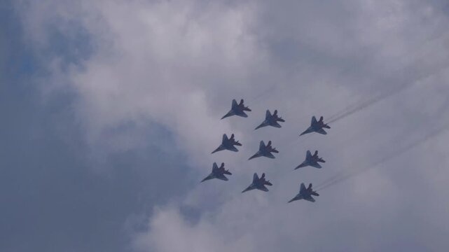 25 July 2021, Russia, Zhukovsky. Russian aerobatic team Swifts performs advanced aerobatic maneuvers in the sky during an air show, demonstrating precision flying and military aviation.
