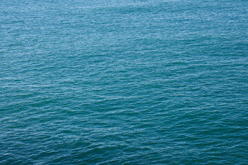 Fototapeta premium Calm ocean waves rolling under light bright blue water ripples texture pattern Batumi Georgia Black Sea Calm lake surface reflecting under Day light Summertime Summer season