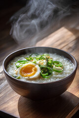 Bowl of congee with green onions and soy marinated egg in a ceramic bowl with rising steam on wooden table evoking gentle comfort and warmth  
