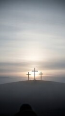 Obraz premium Three Christian cross silhouettes on a hill at sunset. Religious Easter holiday concept for faith, hope and salvation.