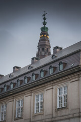 Fototapeta premium Crowned tower and statues atop historic Danish building