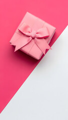 Pink gift box with bow ribbon on a pink and white background for celebration. Vertical template for  birthday, anniversary, gift giving concept. Minimalist design with copy space.