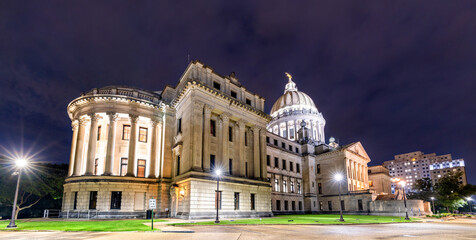 Mississippi State Capitol building stands in Jackson, USA. Historic Beaux-Arts architecture features the illuminated dome and stone columns under a dark night sky