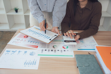 Financial Acumen: Professionals in a collaborative environment assess performance charts and financial data, focused on fiscal planning and strategic decision-making.