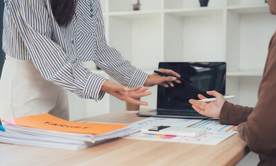 Meeting of Minds: A collaborative discussion unfolds in a modern office space, capturing a moment of business interaction and thoughtful deliberation.