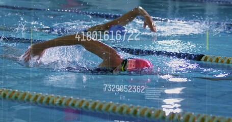 Swimming woman in pink cap goggles one-piece stroking in meet pool with yellow-black ropes overlay
