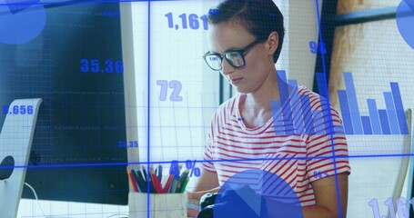 Handling device, woman with glasses in striped shirt at home-office with monitor, pencils and data