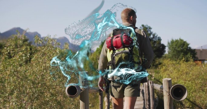 Walking hiker in hiking gear on boardwalk, carrying green backpack with red pad and blue particle - Powered by Adobe
