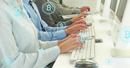 Typing coworkers hands at office desk with white keyboards, monitors and Bitcoin symbols in suits