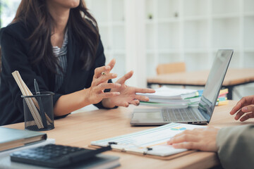 Collaborative Business Discussion: Capturing a moment of focused teamwork, two professionals engage in a strategic business meeting.