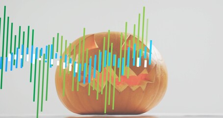 Glowing carved jack-o'-lantern pumpkin sitting on pale tabletop with green blue white waveform bars
