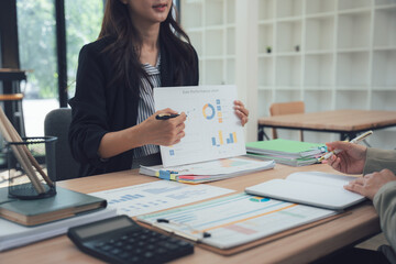 Business Presentation: A professional woman passionately presents financial data during a focused business meeting.