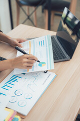 Analyzing the Data: A close-up captures a person immersed in detailed financial analysis, reviewing charts and graphs.