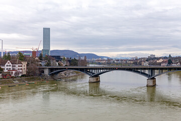 Bridge crosses Rhine River in Basel Switzerland with modern buildings