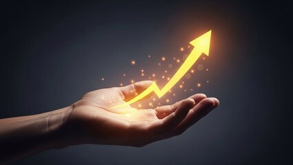 Hand holding a vibrant glowing orange arrow symbolizing energetic business growth and positive market trends.