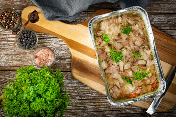 Jelly with shredded chicken meat in a mold.