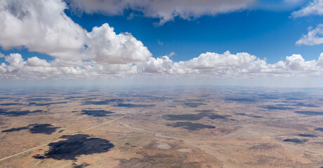 cumulus clouds above barren countryside, near Kobos, Namibia
