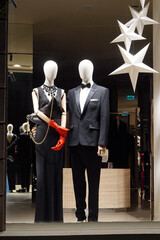 Elegant attire of woman and man in the window of a fashion shop in Bucharest