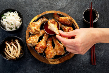 Baked chicken wings in asian style with sauces.