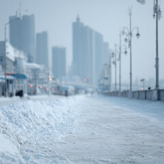 Snowy urban waterfront in winter, blurred city background, cold weather, minimalism, silence, empty space.
