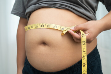 Asian woman with fat belly big size overweight and obesity with measure tape.