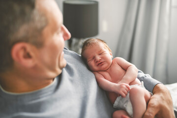 Fototapeta premium Father with his cute newborn baby indoors