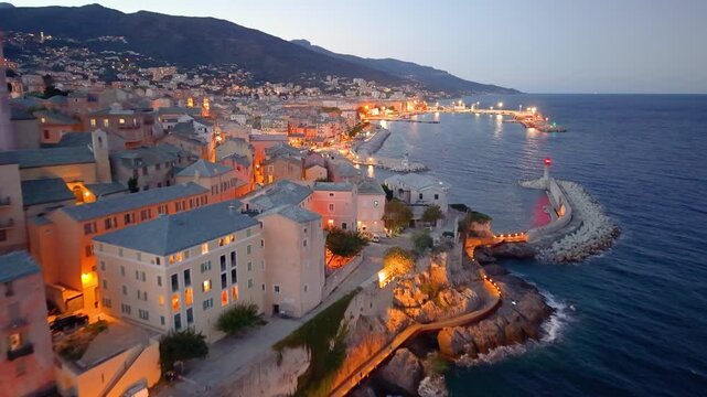 picturesque harbor during twilight hours, historic fortress overlooks tranquil water at evening. Bastia. France