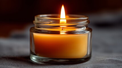 Traditional memorial candle lit during Yahrzeit observance in a simple setting
