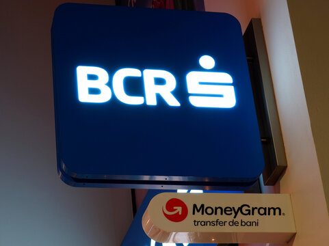 Bucharest, Romania &ndash; January 2, 2026: BCR Bank and MoneyGram logos above entrance in a retail office of BCR Bank