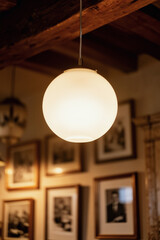 Warm glowing frosted glass pendant light in cozy vintage interior