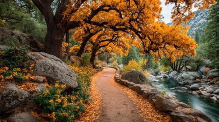 Autumnal path winding through a park-like landscape, lined by vibrant golden trees and a tranquil creek
