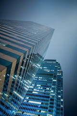 Modern glass skyscrapers rising toward the sky in Hong Kong, China. Abstract view of corporate architecture symbolizing business growth, finance and global economy