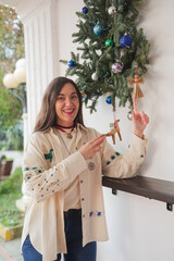 embroidered costume decorating a home porch with handmade straw ornaments shaped as an angel and a horse, symbolizing Ukrainian folk traditions and winter holidays.