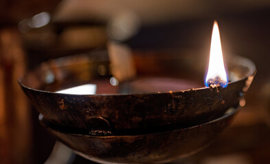 Hong Kong, China : ritual oil lamp burning inside Man Mo Temple, close-up view of a traditional flame used during Taoist worship and prayer