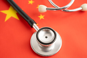 Stethoscope on China flag, business and finance.
