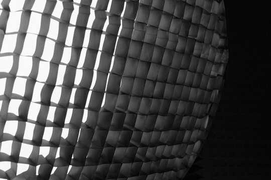 Abstract softbox grid pattern with light and shadow, geometric texture background for creative lighting, design and visual concepts.